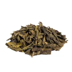 Spilled green tea China Sencha on a white background, side view