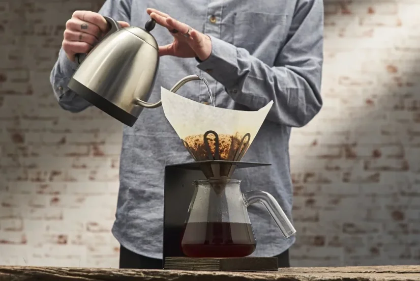 Príprava kávy vo EB Lab Flower V60 s kávou vo filtri a kanvicou.