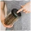 Transparent container for coffee and tea with a volume of 1200 ml and a black lid;