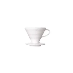 White ceramic Hario V60-01 dripper on a light background. White ceramic Hario V60-01 dripper on a light background.