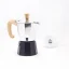 Silver moka pot with a wooden handle and black water tank, Forever Miss Moka Woody for 2 cups with a cup of coffee.