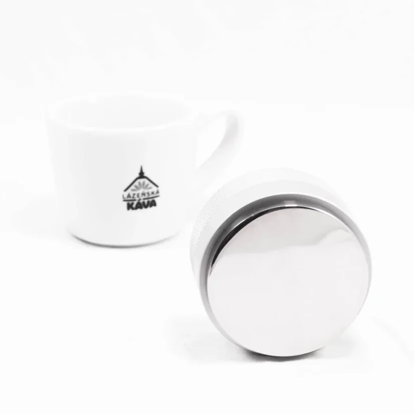 Base of the tamper with coffee in the background.