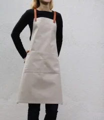 Beige barista apron with pockets, front view Beige barista apron with pockets, front view