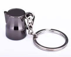 Black keychain in the shape of a milk jug.