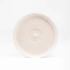 White Huskee saucer leaning on the edge