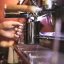 View of a Barista and Co Dial Milk Pitcher with a 600ml capacity during milk frothing. 