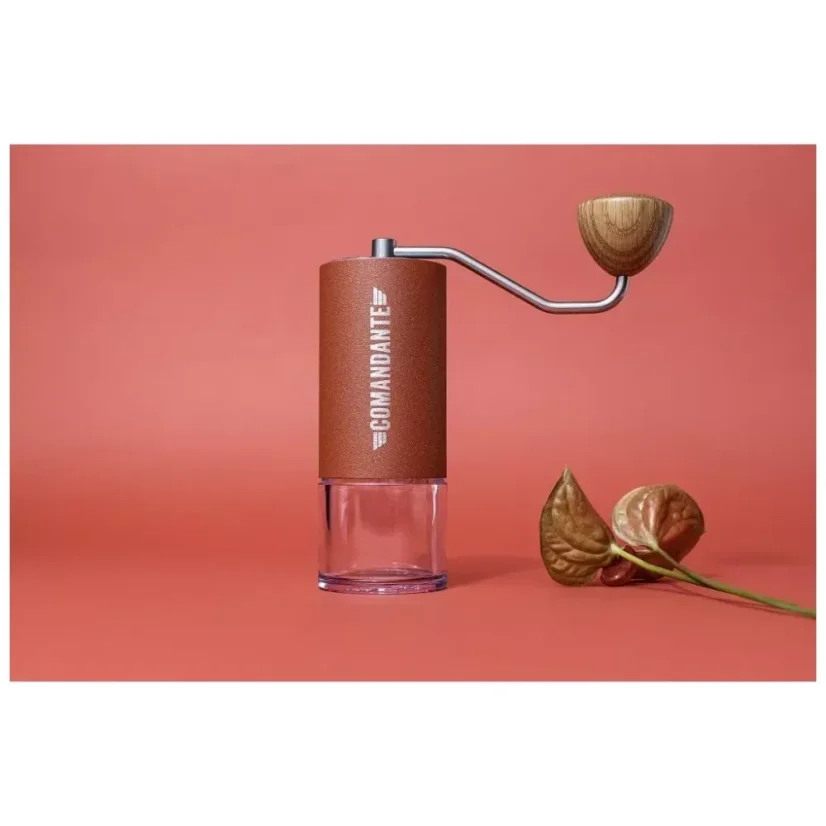 Manual Comandante coffee grinder in red on a red background.