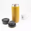 View of an unfolded yellow Kinto Travel Tumbler Coyote 500ml thermos alongside a porcelain cup of coffee. View of an unfolded yellow Kinto Travel Tumbler Coyote 500ml thermos alongside a porcelain cup of coffee.