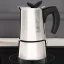 Bialetti Musa kettle in use on an induction cooktop.