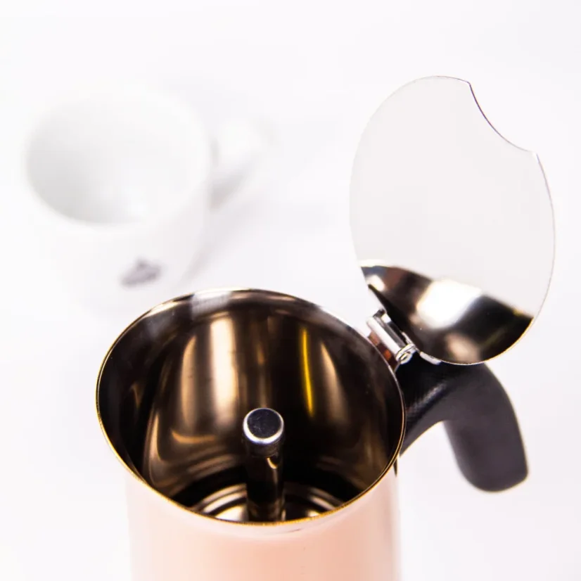 Bialetti New Venus moka pot for 4 cups on a white background with a cup of coffee, view into the interior of the pot.