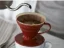 Red ceramic Hario V60-02 drip coffee maker (model VDC-02R) with a capacity to prepare up to 4 cups of coffee.