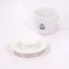 White electric kettle lid on a white background with a cup of spa coffee