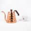 Hario Buono copper teapot with a volume of 0,9l next to the cup of Spa Coffee.