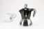 Aluminum Moka pot suitable for induction with the logo of the Italian manufacturer Bialetti, composed with a cup featuring a coffee logo.