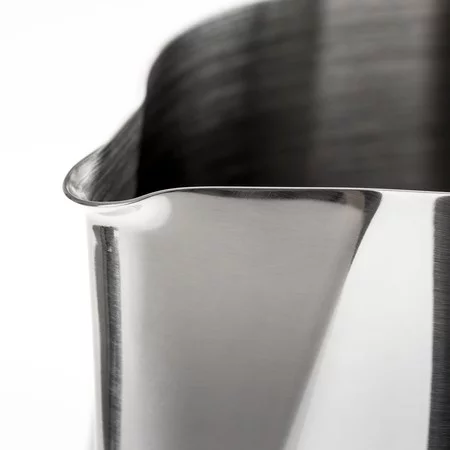 Stainless steel milk pitcher 600 ml on a white background, detail on the spout