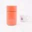 Coral-colored thermal bottle with a capacity of 295 ml on a white background with a cup of coffee.