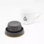 Black lid of a yellow Kinto Travel Tumbler Coyote 500ml with a cup of coffee on a white background Black lid of a yellow Kinto Travel Tumbler Coyote 500ml with a cup of coffee on a white background