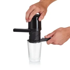 Schwarzer Hand-Kaffeefilter "Twist Press" auf einem Papierfilter, im Prozess auf einem Glas platziert.