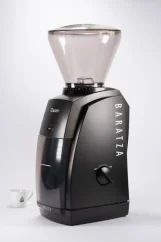 Black electric Baratza Encore grinder with a cup of coffee. Black electric Baratza Encore grinder with a cup of coffee.