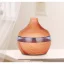 Wooden electric aroma diffuser in the shape of a volcano.