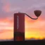 The Comandante C40 MK4 Nitro Blade manual coffee grinder in Sunset colour is the perfect companion for coffee enthusiasts. Its attractive red colour adds a modern touch to the kitchen.