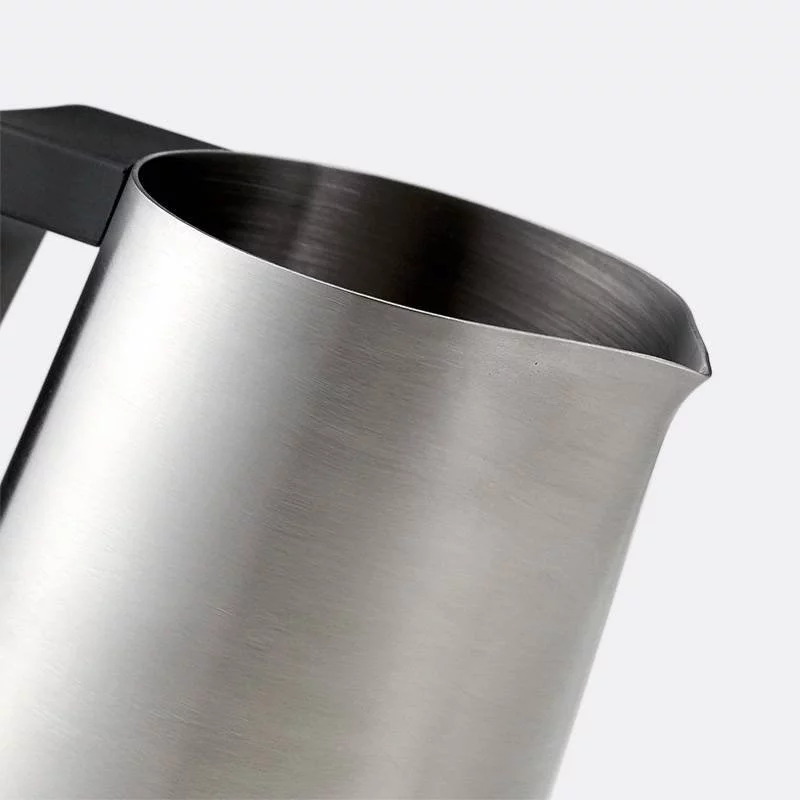 Silver Subminimal Flowtip milk pitcher on a white background, detail of the pitcher's spout