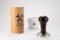 Heavy Tamper base 58.6 mm and a cup of coffee Heavy Tamper base 58.6 mm and a cup of coffee