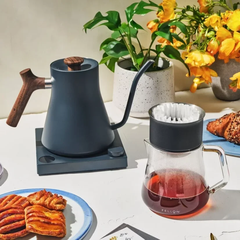 Fellow Stagg EKG Electric Pour-Over Kettle in blue with a wooden handle and Fellow pour-over set.