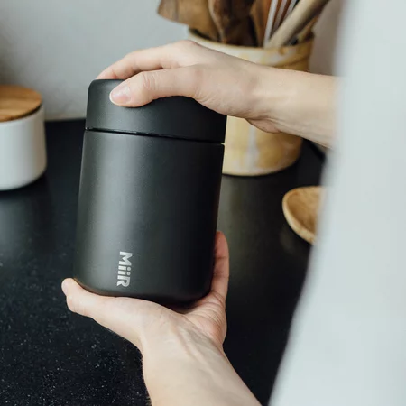 White Miir vacuum coffee canister keeps your coffee fresh.