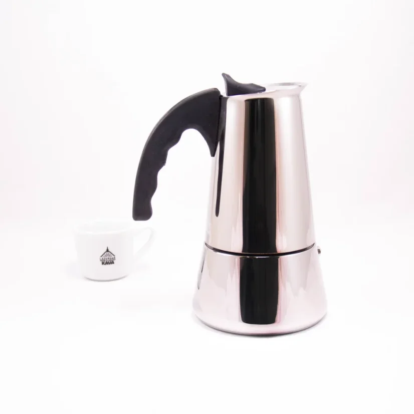 Silver moka pot with a black handle for 10 cups on a white background with a cup of coffee, side view.
