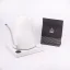 White electric kettle on a white background with a package of spa coffee