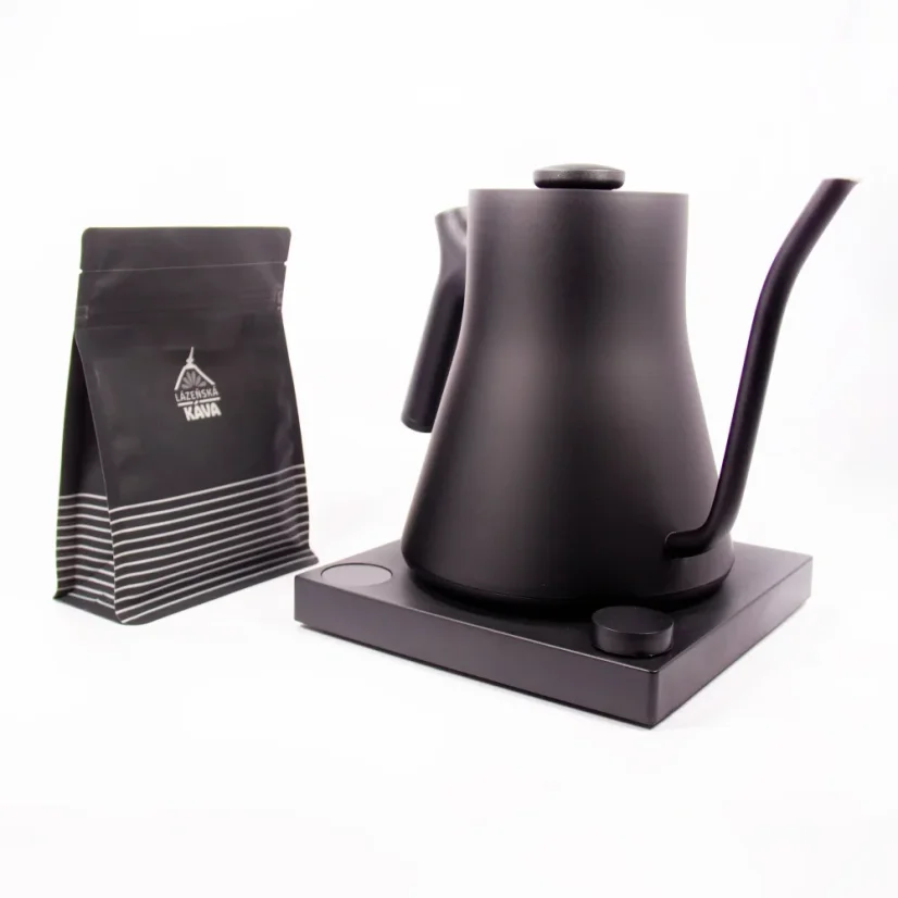 Black electric kettle on a black base with a white background, side view