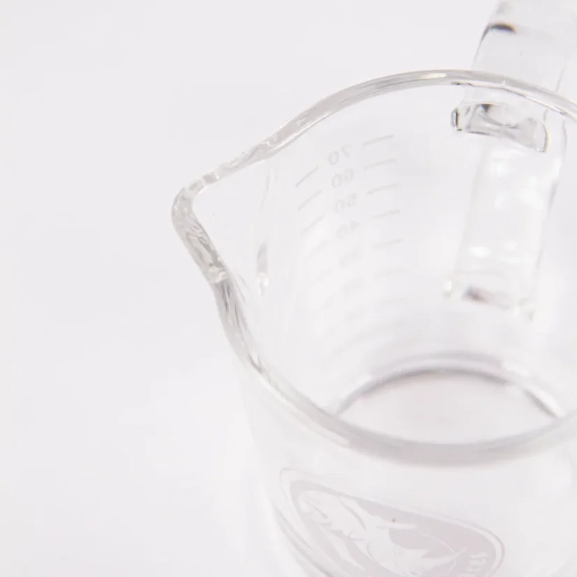 Top view of a Rhinowares Double Spout Shot Glass measuring cup for baristas on espresso.