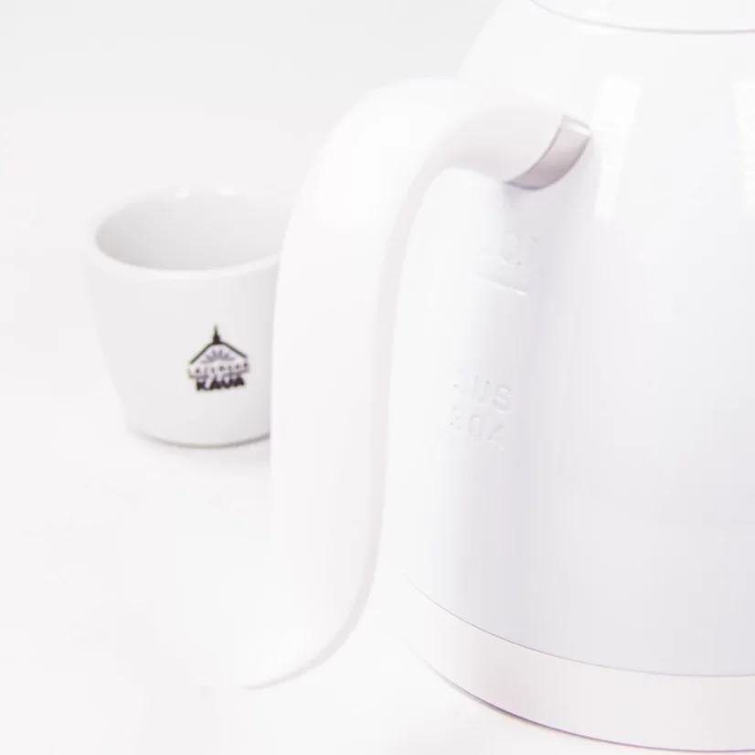 Close-up of the handle for comfortable handling of a Brewista kettle with a cup featuring a logo in the background.