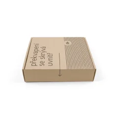Boîte en papier marron avec inscription "une surprise se cache à l'intérieur" sur un fond blanc.