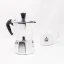 Silver Bialetti Moka Express pot for 2 cups on a white background with a cup of coffee Silver Bialetti Moka Express pot for 2 cups on a white background with a cup of coffee