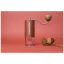 Manual Comandante coffee grinder in red on a red background.
