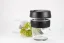 Gobelet thermique en verre avec couvercle noir et support en caoutchouc noir d'une capacité de 340 ml, décoré d'une petite branche et d'une tasse de café.
