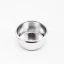Silver portafilter basket on a white background, top view of the inner part of the basket.