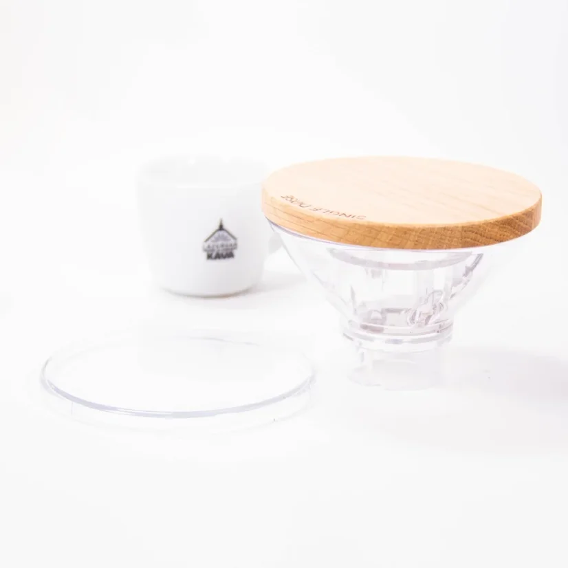 Grinder hopper by Eureka, next to a cup with the spa coffee logo.