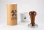 58.6 mm Heavy Tamper Classic Walnut and a cup of coffee