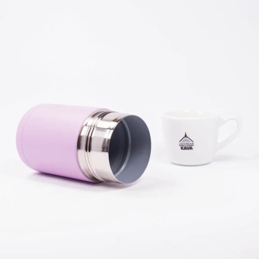 Pink thermos flask with a capacity of 295 ml lying on a white background with a coffee cup.