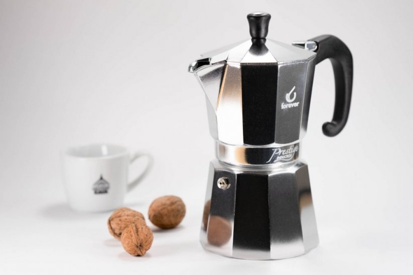 Aluminium moka pot with cup of spa coffee and nuts