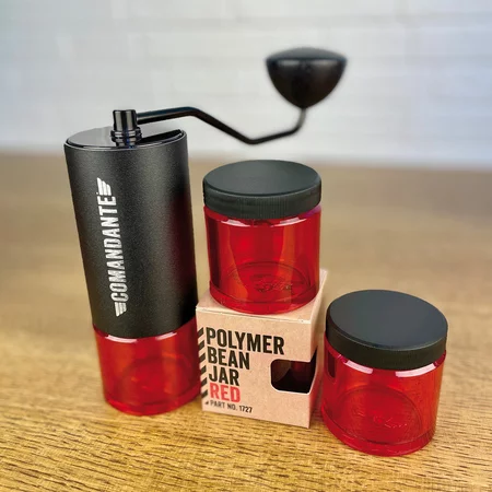 Red Comandante coffee container, ideal for storing freshly ground coffee.