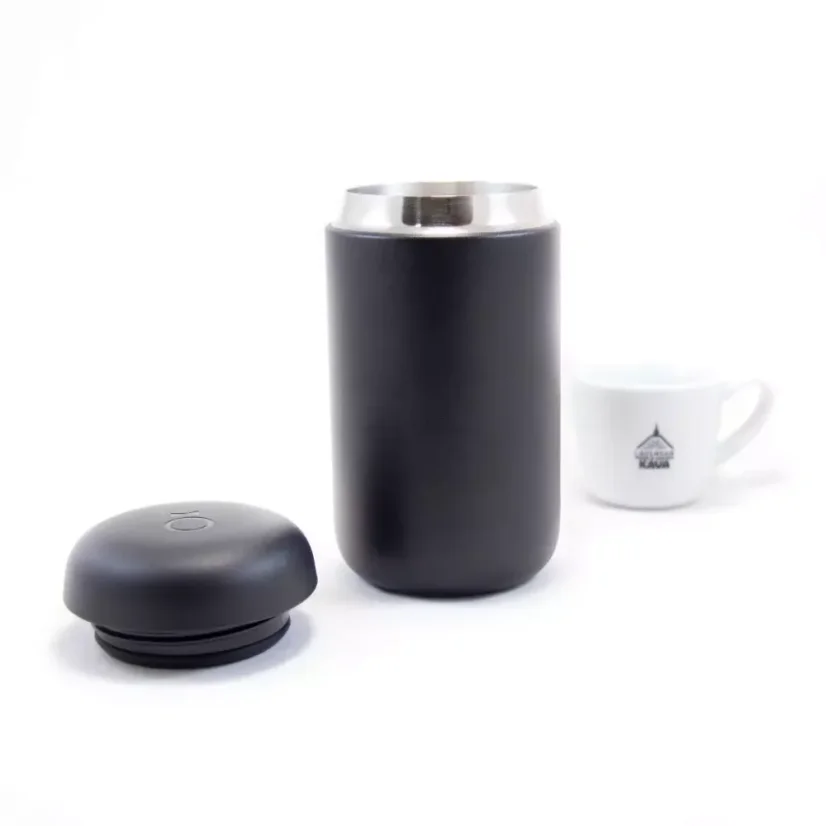 Detail of travel mug parts with coffee in the background