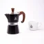 Moka pot Forever Prestige Radica next to an espresso cup with a coffee logo.