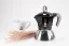 Aluminum Moka pot suitable for induction with the logo of the Italian manufacturer Bialetti, composed with a cup featuring floral motifs.