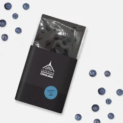 Dark 70% chocolate with blueberries in a black label on a white background with blueberries Dark 70% chocolate with blueberries in a black label on a white background with blueberries