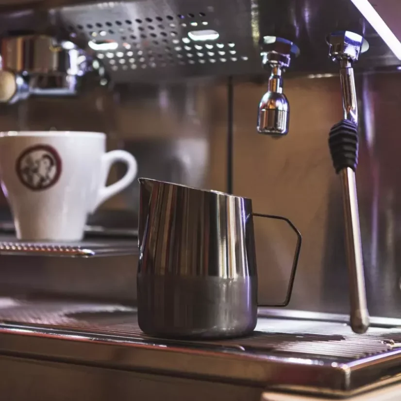 Nerezová kanvica od značky Barista a Co Dial in Milk Pitcher 420 ml vo tmavom prevedení na kávovare s tryskou určenou na šľahanie mlieka a s šálkou