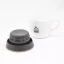 View of the underside of the Kino Travel Tumbler Khaki 500ml lid with a white cup of coffee in the background.